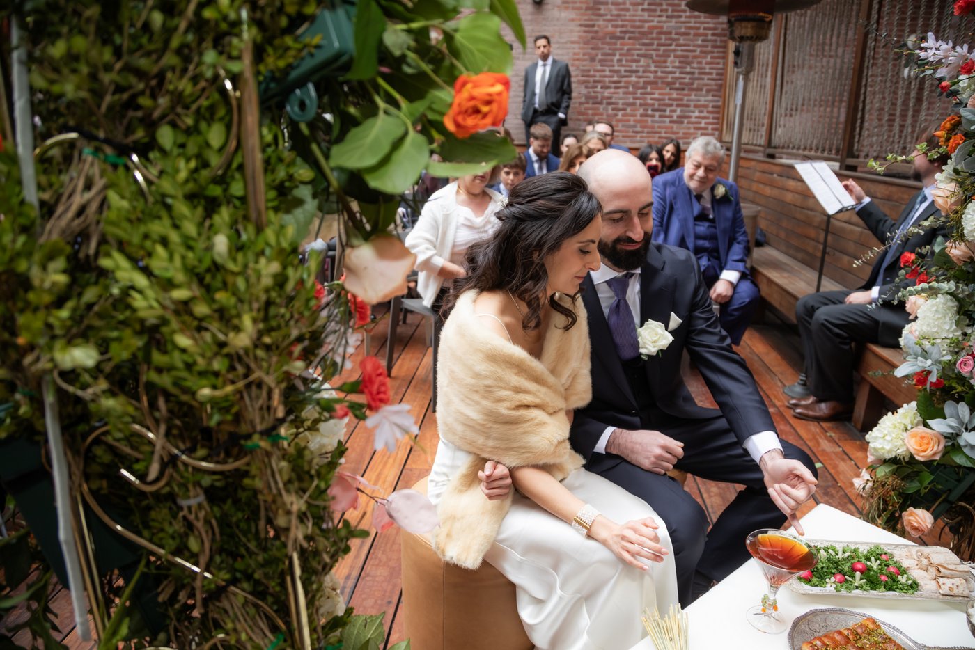 Bride and groom during ceremony, in front of Persian sofreh aghd table at SRV Boston.
