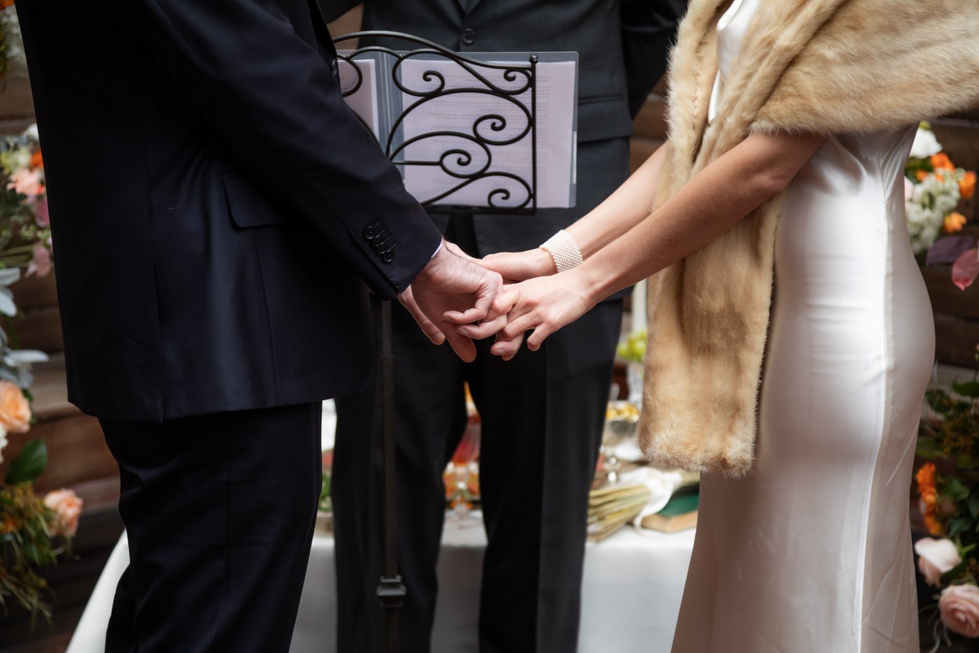 Bride and groom hold hands at SRV Boston wedding.