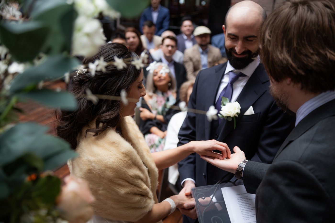 Bride and groom exchange rings during their SRV Boston wedding.