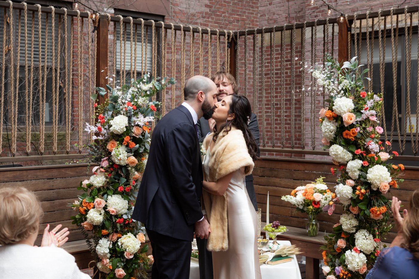 The Bride and groom share their first kiss at the altar during their SRV Boston wedding.