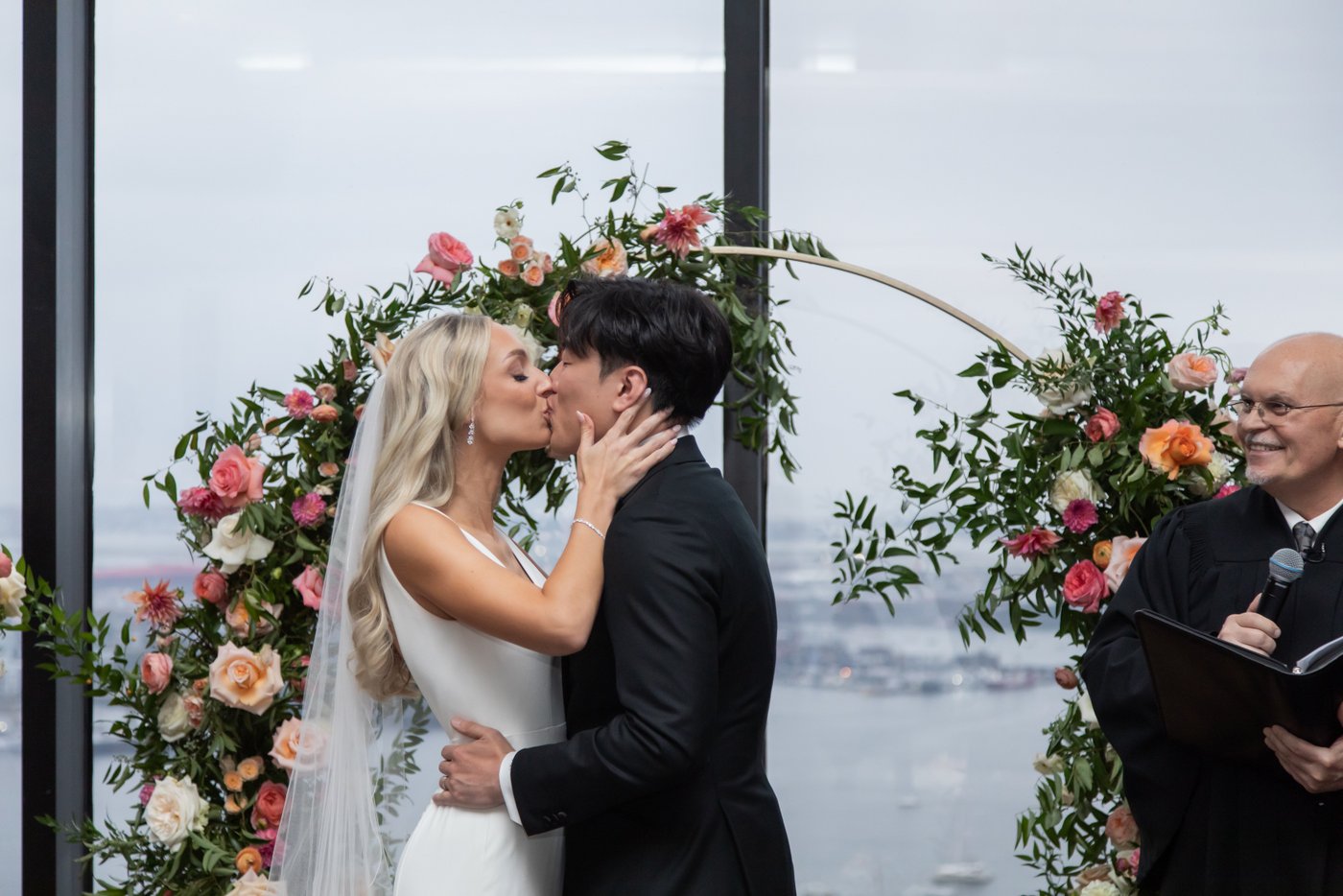 The bride and groom share their first kiss at the altar at their State Room Boston wedding