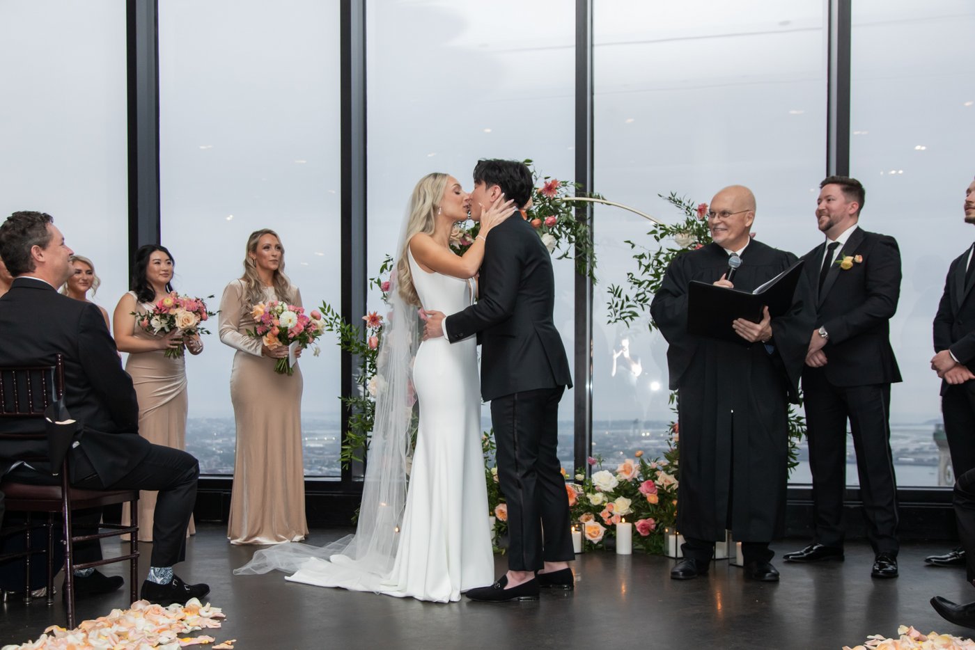 The bride and groom share their first kiss at the altar at their State Room Boston wedding