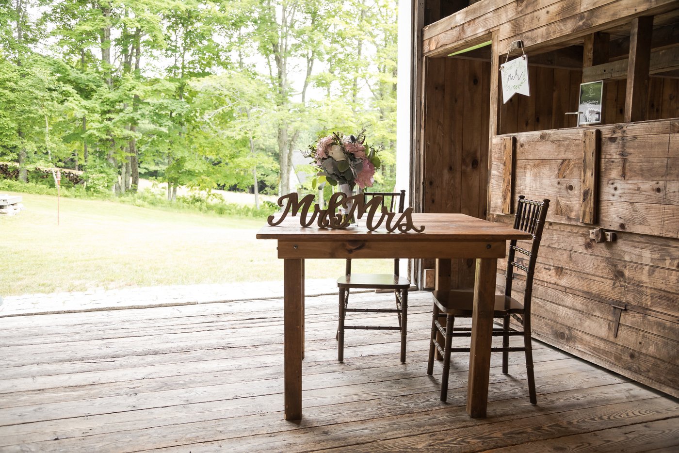 The rustic sweetheart table at a barn wedding in Massachusetts