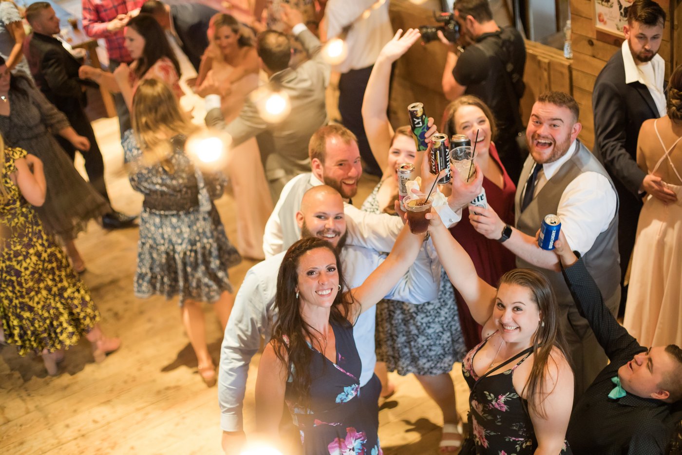 Guests raising their glasses at a barn wedding in Massachusetts