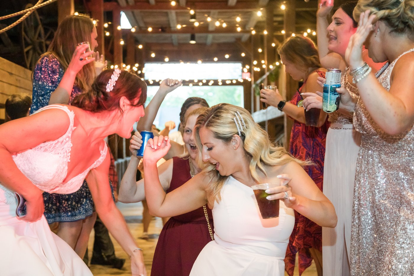 Guests dancing under string lights at a farm wedding in Massachusetts