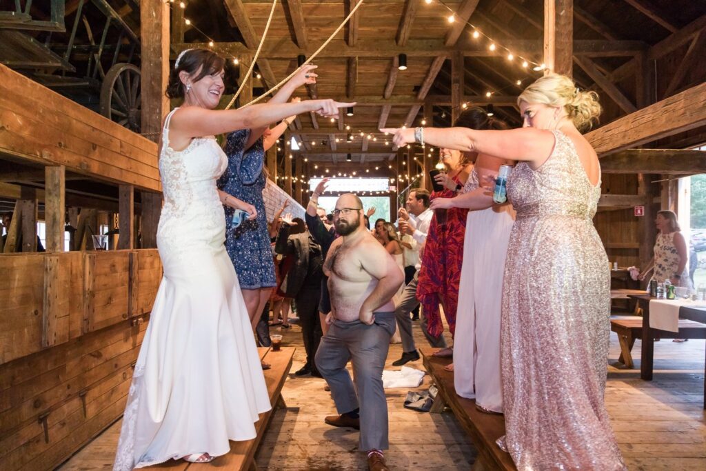 The bride and a bridesmaid pointing at each other