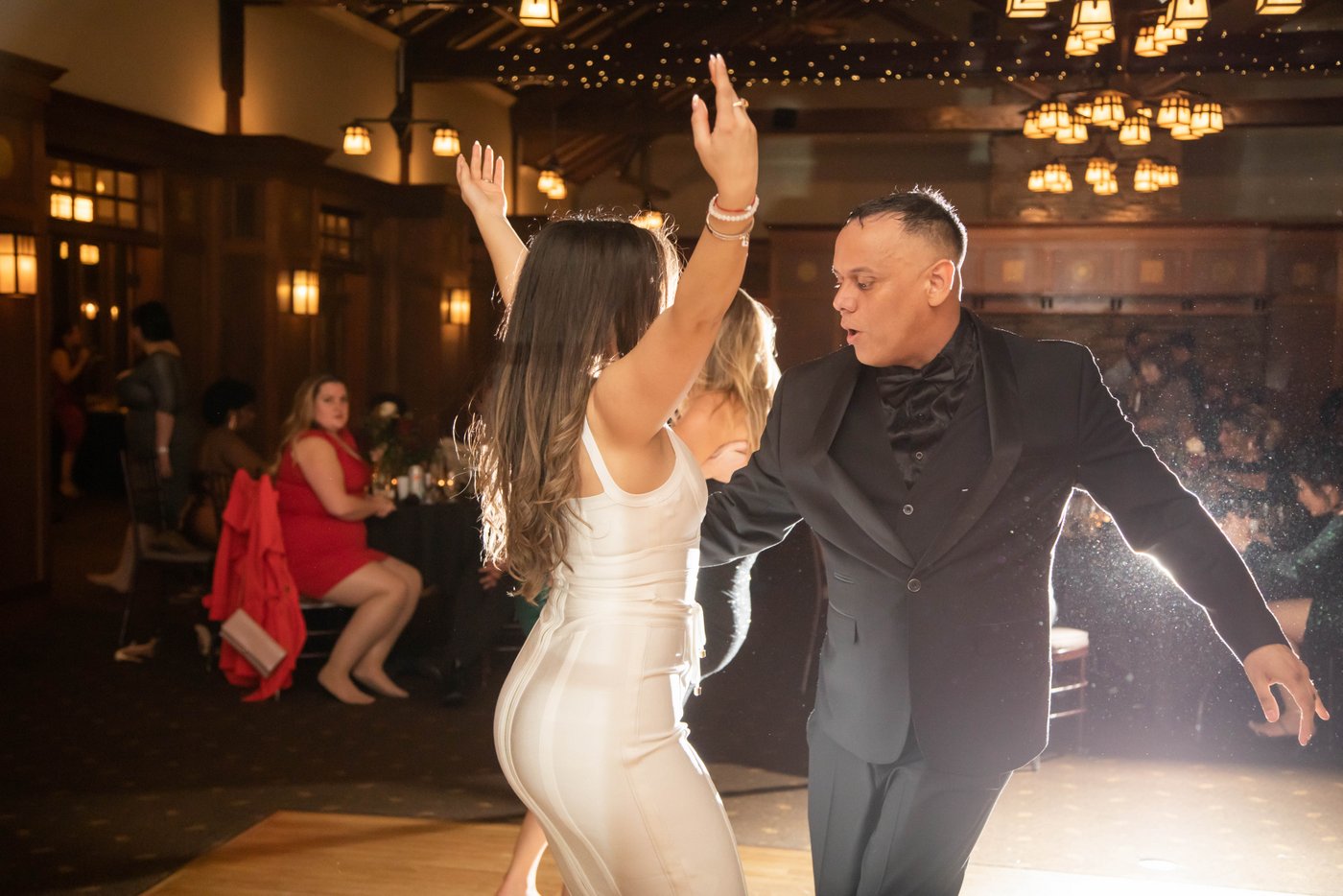 A bride and a groom dancing together at a wedding at the Garden House at Look Park in Northampton, photographed with the use of backlighting flash by Boston's best creative wedding photographers, Spagnolo Photography.