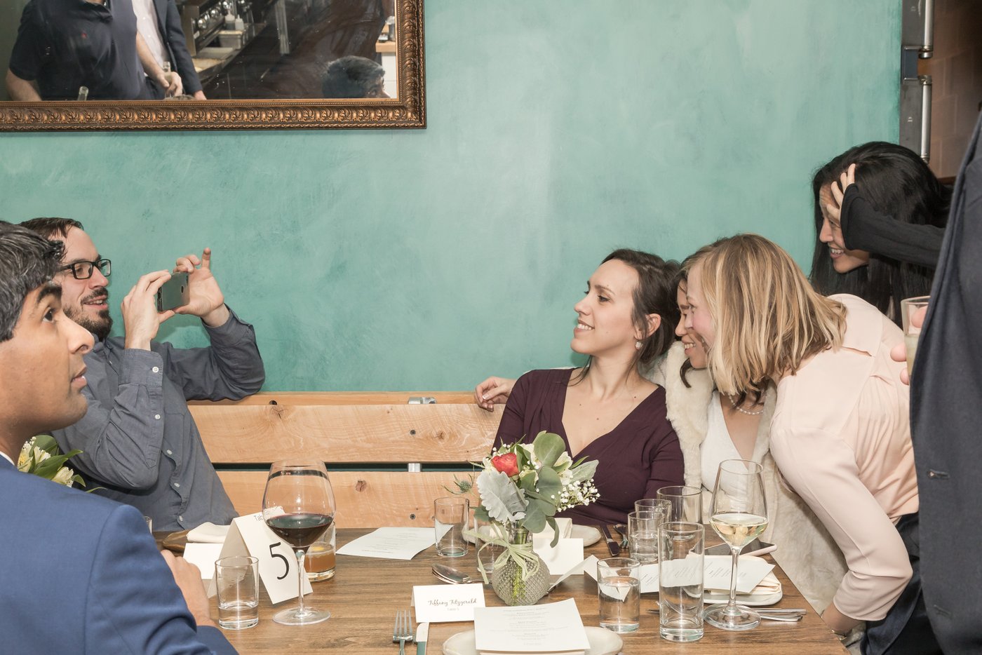 A candid shot of guests interacting during a Sarma Restaurant wedding in Somerville