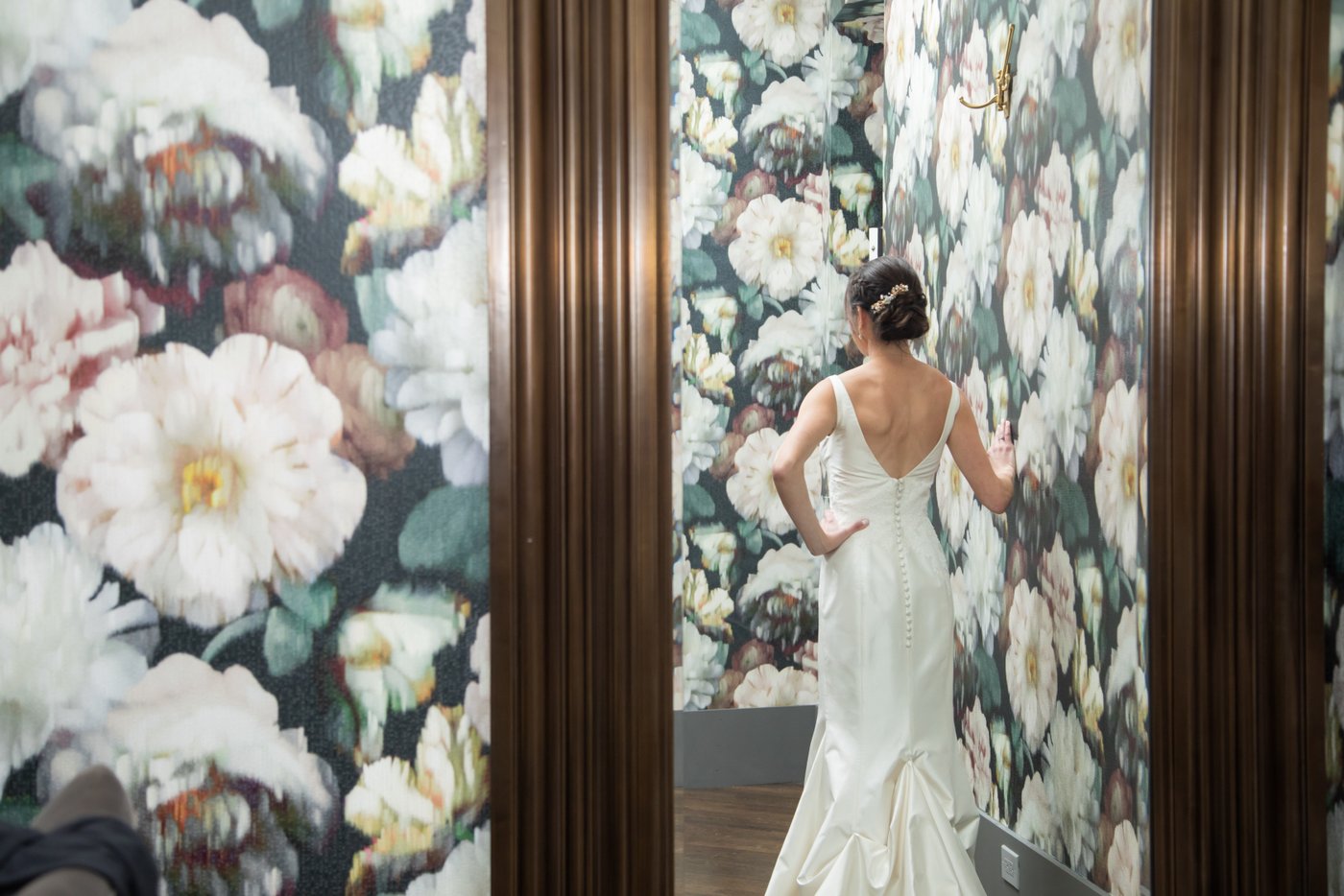 The back of the bride's dress shot though a mirror