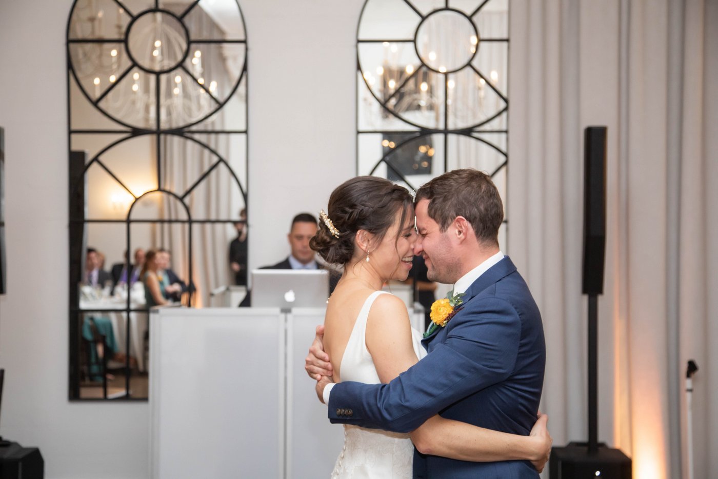 Bride and groom rest their foreheads together during their first dance at fall wedding in Brookline