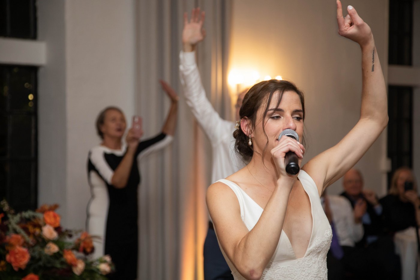 Bride singing at fall wedding in Brookline MA