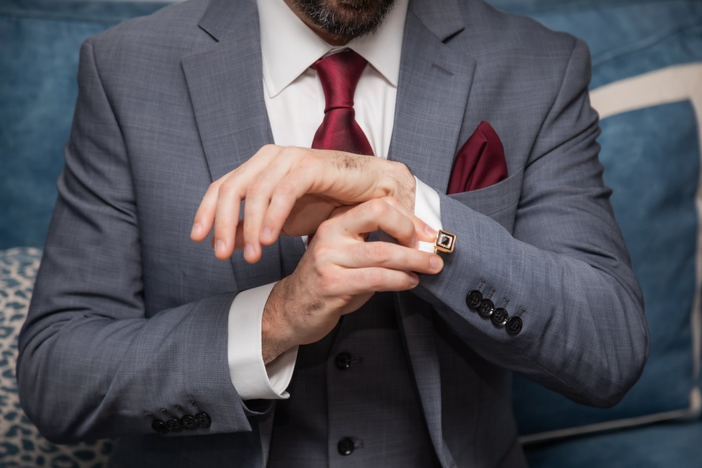 The groom adjusting his cufflinks