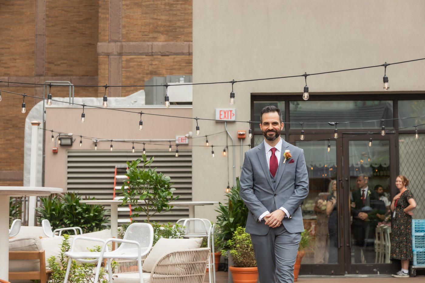 The groom walking toward the altar at the rooftop wedding ceremony at Terra at Eataly in Boston