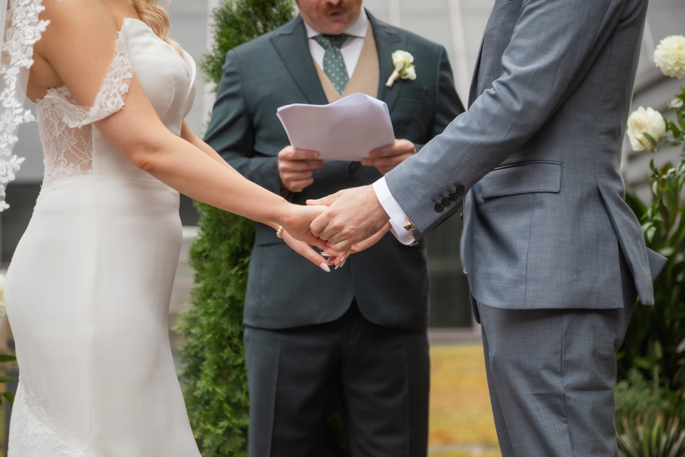 A close up photo of a bride and a groom's hands holding each other during their Terra at Eataly micro wedding on the rooftop