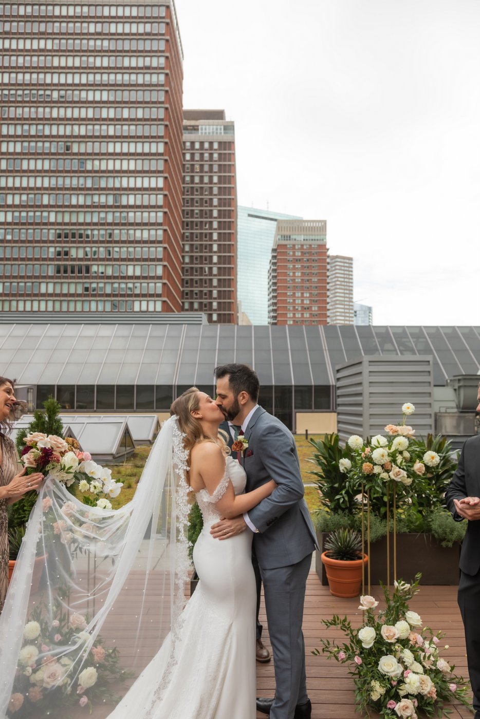 A bride and groom kiss on the rooftop of Terra at Eataly during their micro-wedding ceremony, photographed by Spagnolo Photography for their micro-wedding photography package.