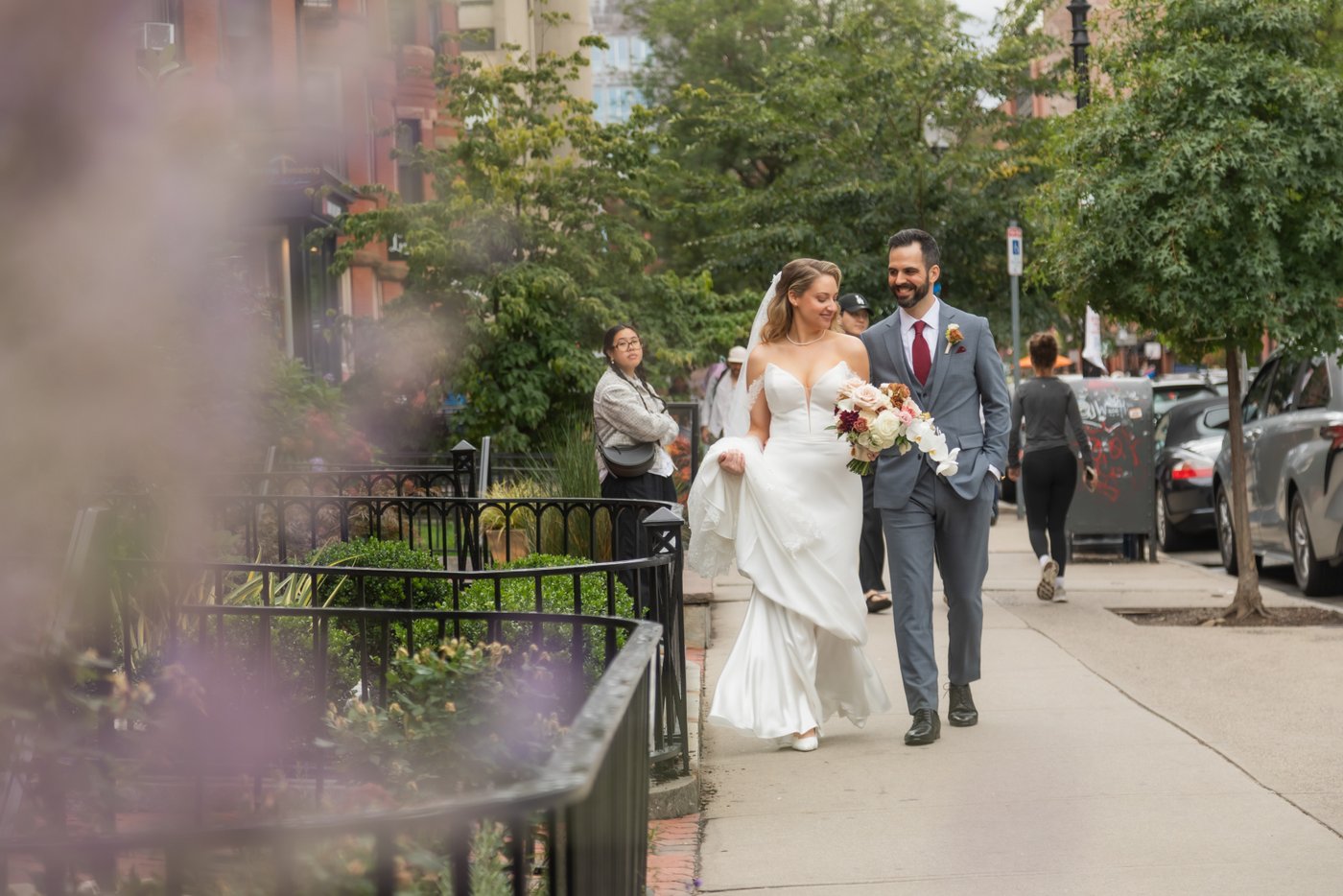 A bride and a groom walking down Newbury Street in Boston during their Terra at Eataly wedding