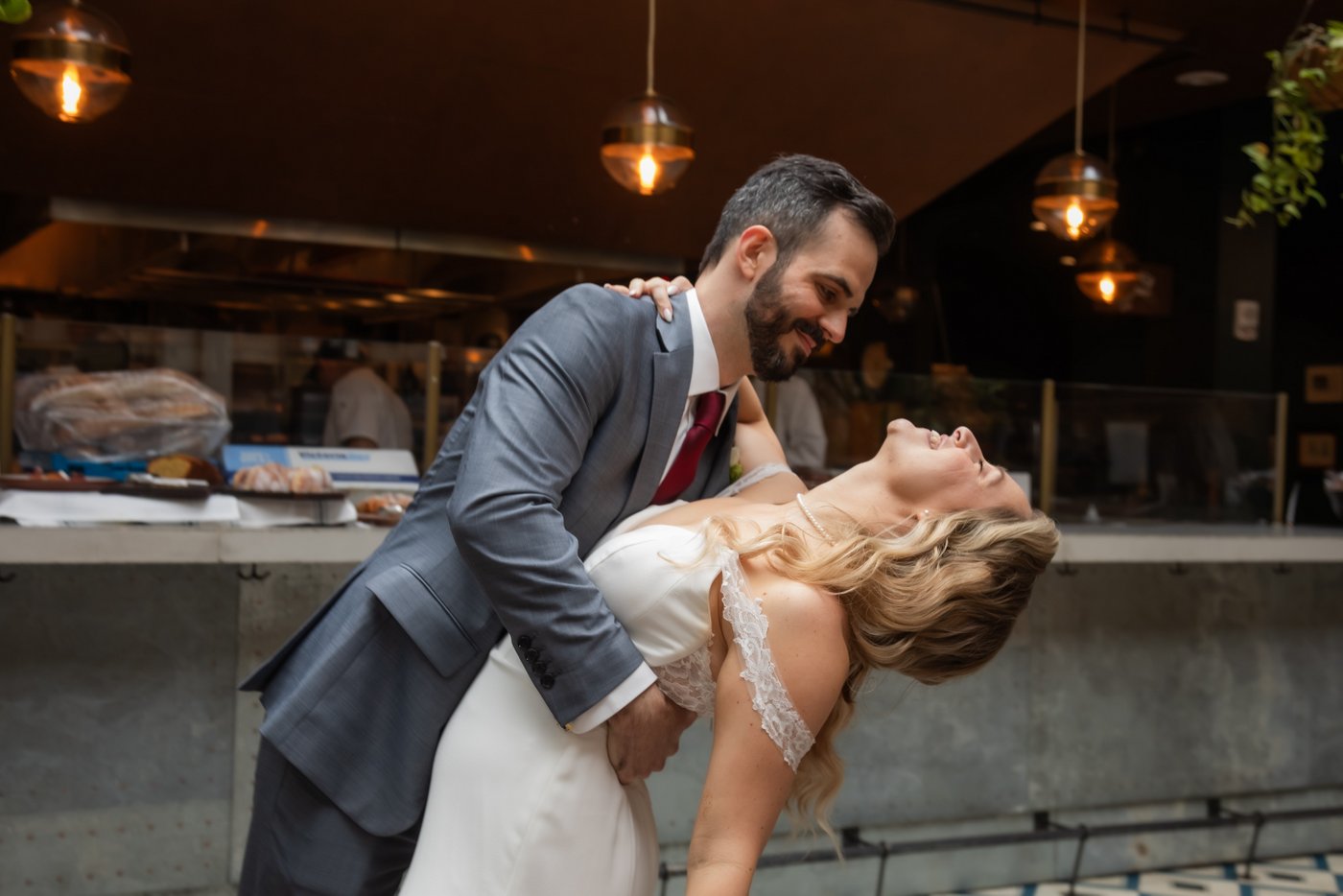 The groom dips the bride during their first dance at their Terra at Eataly wedding in Boston