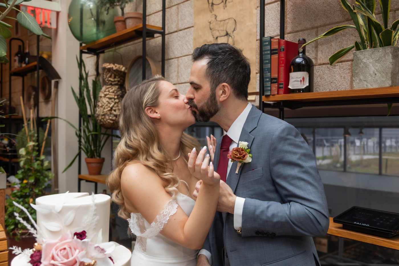 The bride and the groom kissing after the cake cutting at a Terra Boston wedding