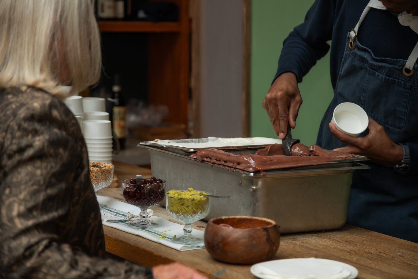 A waitstaff scooping chocolate gelato for a wedding guest at Terra at Eataly in Boston