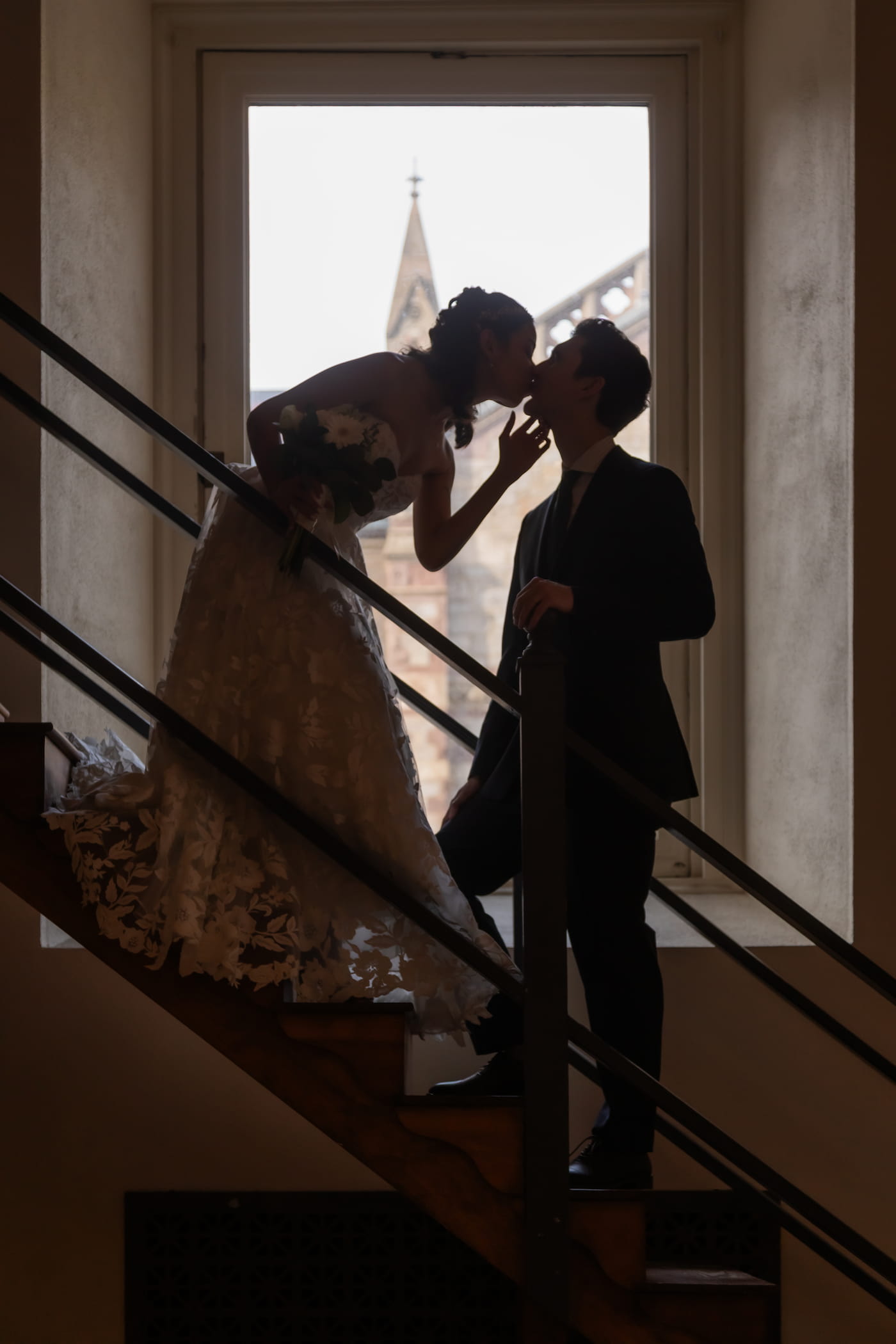 A bride and a groom kiss at the Boston Public Library after their one hour wedding ceremony
