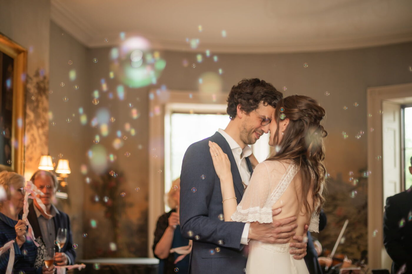 A bride and a groom hold each other as they dance their first dance during their wedding at the King's Chapel Parish House in Boston's Beacon Hill neighborhood.