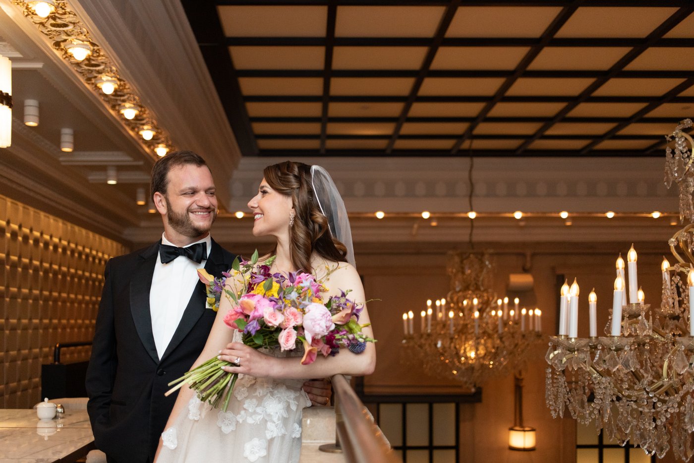 A creative wedding portrait of a bride and a groom on the balcony of the Grana restaurant, during their Langham Boston wedding