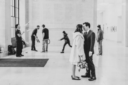 An MIT Elopement in Black & White A bride and groom kiss inside the main MIT building after their elopement, photographed in black and white by Boston-based photographers Spagnolo Photography as part of a set of photographs shot in a unique creative style reminiscent of an indie movie