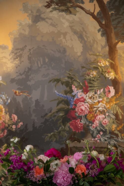 A floral arrangement and a renaissance painting at the King's Chapel in Boston during a micro-wedding