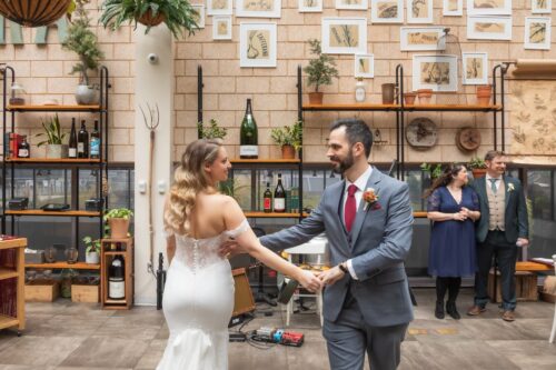 A bride and groom dance during their micro-wedding reception at Terra Eataly, photographed by Spagnolo Photography for their photography package.