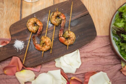 Shrimp on skewers served on a wooden board at a Terra at Eataly micro-wedding.